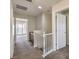 Upstairs hallway with carpet, white railing and access to other rooms in the house at 1064 Calvia St, Las Vegas, NV 89138