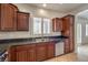 Kitchen with stainless steel dishwasher and sink, granite countertop and plenty of wood cabinets at 1064 Calvia St, Las Vegas, NV 89138
