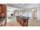 Kitchen with large center island, tile flooring, view to the living room with fireplace and staircase at 1064 Calvia St, Las Vegas, NV 89138