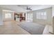 Open floor plan with tile flooring, a fireplace, ceiling fan, and windows with plantation shutters at 1064 Calvia St, Las Vegas, NV 89138