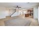 Spacious open-concept living space features tile flooring, ceiling fan, and seamlessly connects to the kitchen at 1064 Calvia St, Las Vegas, NV 89138
