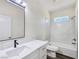 Clean bathroom featuring a single sink vanity with marble countertop and a tile enclosed tub and shower at 1351 Huckleberry St, Pahrump, NV 89048