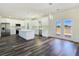 Bright open concept kitchen features stainless steel appliances, white cabinets, and an island at 1351 Huckleberry St, Pahrump, NV 89048