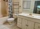 Bathroom with white vanity, tiled floors, and a shower-tub combo, offering a functional and bright space at 1409 Santa Margarita St # B, Las Vegas, NV 89146