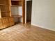 Bedroom featuring durable wood laminate flooring and built-in shelving, creating an organized and comfortable space at 1409 Santa Margarita St # B, Las Vegas, NV 89146