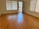 Bedroom with blonde wood floors, two windows with blinds and white walls at 1409 Santa Margarita St # B, Las Vegas, NV 89146