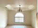Traditional dining room with decorative ceiling detail and a vintage chandelier, bathed in natural light at 1409 Santa Margarita St # B, Las Vegas, NV 89146