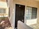 Property featuring a security door and a garden area adjacent to the front door entrance at 1409 Santa Margarita St # B, Las Vegas, NV 89146