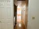 Hallway with blonde wood floors, neutral wall color and white door at 1409 Santa Margarita St # B, Las Vegas, NV 89146
