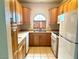 Efficient kitchen featuring oak cabinets, ample counter space, and standard appliances for culinary endeavors at 1409 Santa Margarita St # B, Las Vegas, NV 89146