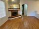 Living room with blonde wood floors, fireplace with brown tile and white walls at 1409 Santa Margarita St # B, Las Vegas, NV 89146