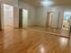 Expansive primary bedroom with mirrored closet doors, laminate flooring and ensuite bathroom with double doors at 1409 Santa Margarita St # B, Las Vegas, NV 89146