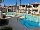 Community pool with in-water lounge chairs surrounded by condo buildings at 1409 Santa Margarita St # B, Las Vegas, NV 89146