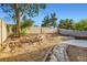 Large backyard featuring brick-lined landscaping and a stone pathway at 1547 Balsam Mist Ave, Las Vegas, NV 89183