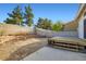 Spacious backyard with mature trees, retaining wall, and a wood deck at 1547 Balsam Mist Ave, Las Vegas, NV 89183