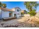 Great backyard featuring sliding glass doors to a wood deck and desert landscaping at 1547 Balsam Mist Ave, Las Vegas, NV 89183