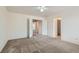 Carpeted bedroom with a ceiling fan, featuring two doorways leading to other rooms at 1547 Balsam Mist Ave, Las Vegas, NV 89183