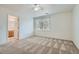 Spacious carpeted bedroom with a ceiling fan and large window overlooking the backyard at 1547 Balsam Mist Ave, Las Vegas, NV 89183