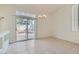 Well-lit dining area with tile flooring and sliding glass doors that open to the outdoor space at 1547 Balsam Mist Ave, Las Vegas, NV 89183