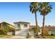 Charming two-story home with a well-maintained yard and Spanish tile roof, complemented by mature palm trees at 1547 Balsam Mist Ave, Las Vegas, NV 89183
