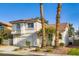 Inviting two-story home with a white stucco exterior, attached garage, and tidy landscaping at 1547 Balsam Mist Ave, Las Vegas, NV 89183