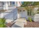 Close-up of the front entrance, featuring a double door, textured walls, and landscaped walkway at 1547 Balsam Mist Ave, Las Vegas, NV 89183
