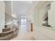 Hallway featuring stairs, tile floors, and an archway looking into the kitchen at 1547 Balsam Mist Ave, Las Vegas, NV 89183