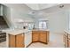 Eat-in kitchen featuring an island with a sink, tile countertops and floors, and white appliances at 1547 Balsam Mist Ave, Las Vegas, NV 89183