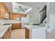 Bright kitchen with white appliances, tile counters and floors, and a modern ceiling fan at 1547 Balsam Mist Ave, Las Vegas, NV 89183