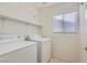 Functional laundry area with modern washer, dryer, and convenient shelving at 1547 Balsam Mist Ave, Las Vegas, NV 89183