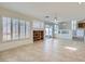 Open-concept living space with tile floors, built-in shelving, and a view of the adjacent dining area and kitchen at 1547 Balsam Mist Ave, Las Vegas, NV 89183