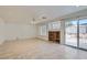 Bright living room features tile flooring, built-in shelving, and sliding glass doors to the backyard at 1547 Balsam Mist Ave, Las Vegas, NV 89183
