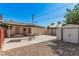 Backyard with patio, shed, and rock landscaping, with a table and chairs to sit and enjoy the yard at 1832 Merze Ave, Henderson, NV 89011