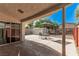 Covered patio with a table and chairs and a shed in the back at 1832 Merze Ave, Henderson, NV 89011