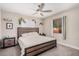 Bedroom features a ceiling fan, carpet, and a window with natural light at 1832 Merze Ave, Henderson, NV 89011
