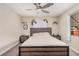 Bedroom features a ceiling fan, carpet, and a window with natural light at 1832 Merze Ave, Henderson, NV 89011