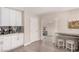 Well-lit kitchen featuring white cabinetry, modern appliances, and a stylish workstation with stools for a convenient cooking experience at 1832 Merze Ave, Henderson, NV 89011