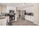Updated kitchen featuring stainless steel appliances, white cabinets and stylish backsplash, creating a delightful cooking experience at 1832 Merze Ave, Henderson, NV 89011