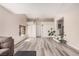 Airy living room showcasing hardwood floors, a cozy gray couch, and ample space for comfortable living at 1832 Merze Ave, Henderson, NV 89011