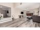 Bright, open living room featuring modern floors, a comfortable couch, and plenty of natural light from the window at 1832 Merze Ave, Henderson, NV 89011