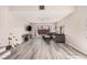 Spacious living room with hardwood floors, gray sectional couch and stylish decor offers a relaxing space at 1832 Merze Ave, Henderson, NV 89011