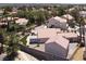 Aerial view of a private backyard with desert landscaping and a covered patio at 2102 Rhonda Ter, Henderson, NV 89074