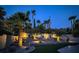 Professionally landscaped backyard with palm trees, cacti, bushes and exterior lighting at 2102 Rhonda Ter, Henderson, NV 89074