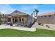 Exterior backyard featuring a covered patio with outdoor seating, dining area, and well-maintained landscaping at 2102 Rhonda Ter, Henderson, NV 89074
