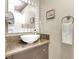 Cozy bathroom features a white vessel sink, granite countertop, and wall-mounted vanity mirror at 2102 Rhonda Ter, Henderson, NV 89074