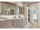 Modern bathroom featuring dual sinks with vessel bowls, designer cabinetry, and a large framed mirror at 2102 Rhonda Ter, Henderson, NV 89074