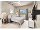 Comfortable bedroom with a ceiling fan and a window letting in natural light at 2102 Rhonda Ter, Henderson, NV 89074