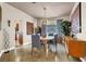 Elegant dining room with modern lighting, stylish decor, and a view to the backyard at 2102 Rhonda Ter, Henderson, NV 89074