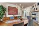 Cozy dining area with a rustic table, modern light fixture, and a decorative fireplace at 2102 Rhonda Ter, Henderson, NV 89074