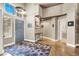Home entryway with blue door, modern light fixture and rug at 2102 Rhonda Ter, Henderson, NV 89074